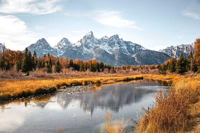 image of mountains behind river and trees